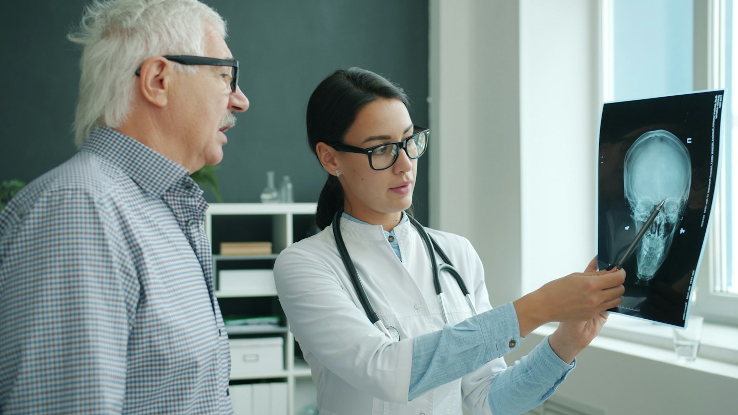 A physician discussing an X-ray with a patient